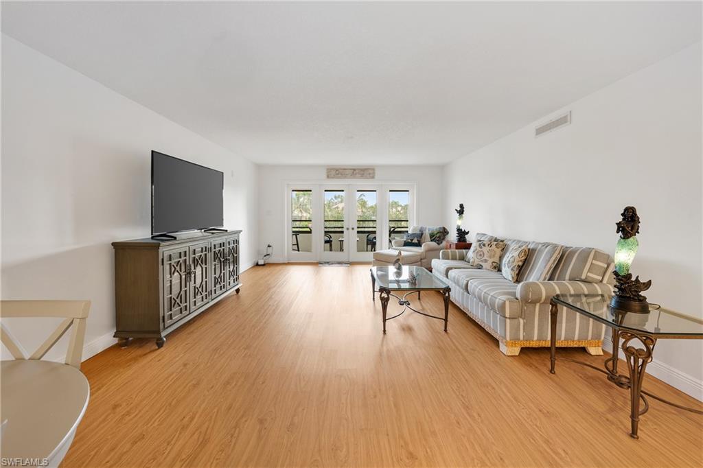801 Islamorada Boulevard, Unit 22B Punta Gorda, FL 33955 - Photo 15 of 48 a living room with furniture and a flat screen tv