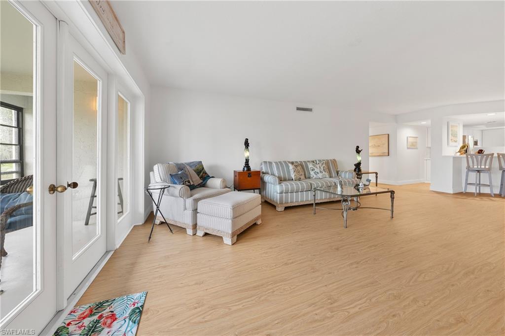 801 Islamorada Boulevard, Unit 22B Punta Gorda, FL 33955 - Photo 16 of 48 a living room with furniture and a wooden floor