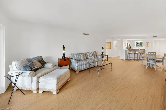 a view of a living room and floor to ceiling window or wooden floor