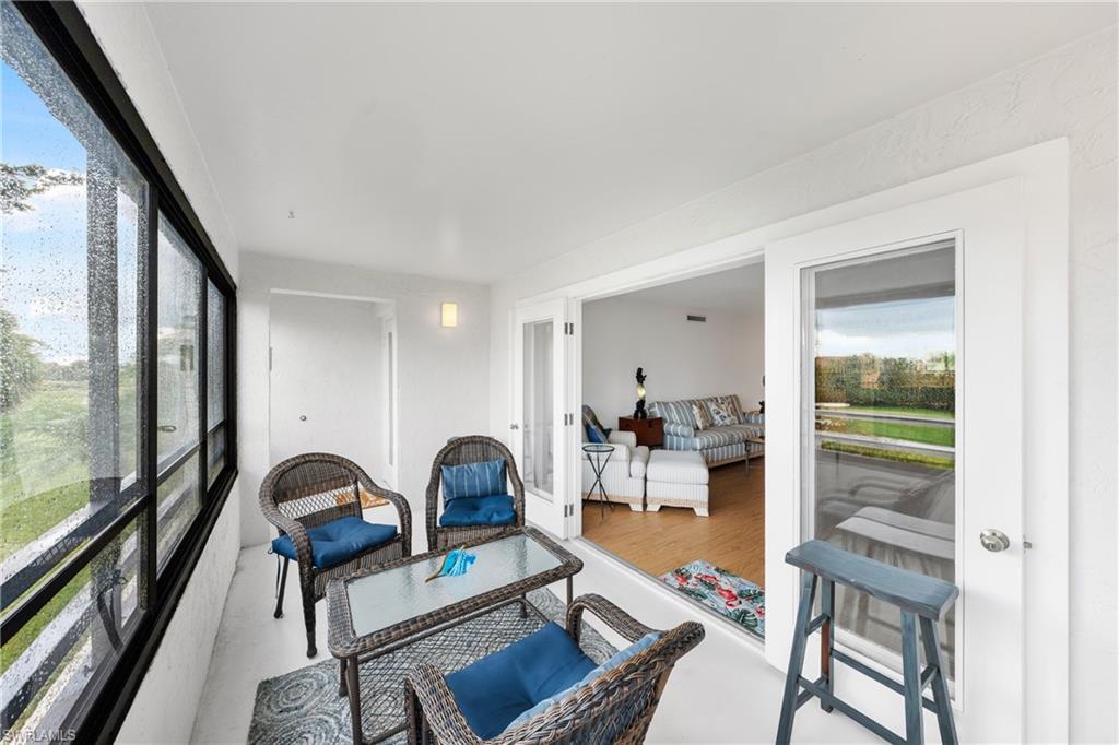 801 Islamorada Boulevard, Unit 22B Punta Gorda, FL 33955 - Photo 19 of 48 a living room with furniture and a large window
