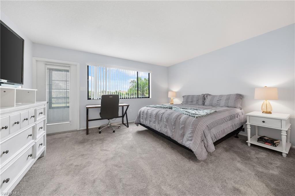 801 Islamorada Boulevard, Unit 22B Punta Gorda, FL 33955 - Photo 20 of 48 a bedroom with a bed and a flat screen tv