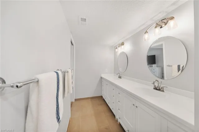 a bedroom with two beds and a couch