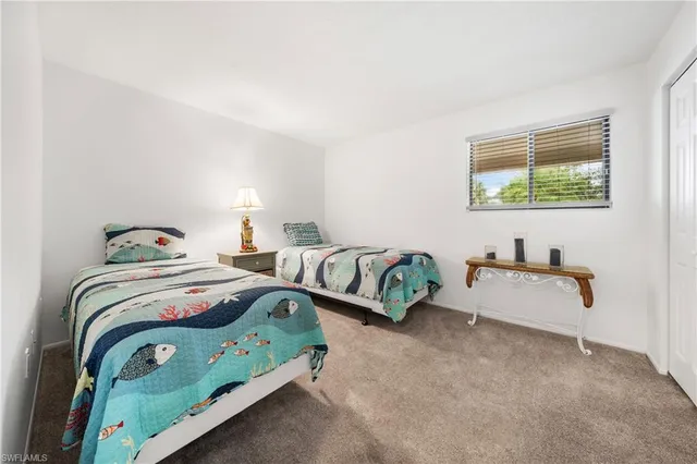 a bedroom with a bed and a table in it