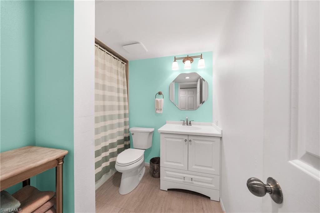 801 Islamorada Boulevard, Unit 22B Punta Gorda, FL 33955 - Photo 26 of 48 a bathroom with a toilet sink and mirror