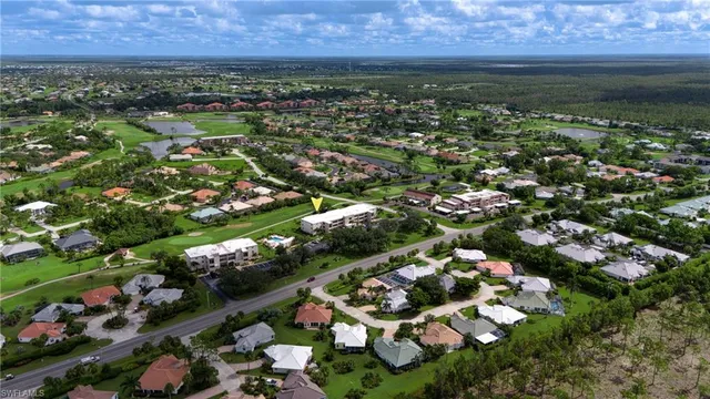 an aerial view of residential houses with outdoor space and swimming pool