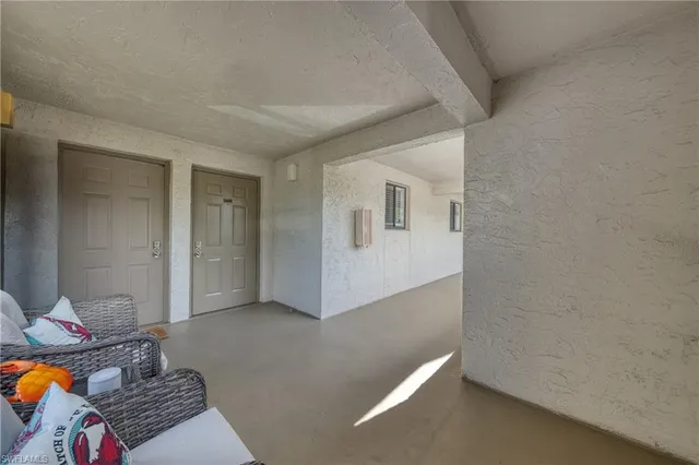 a view of a room with wooden floor and entryway