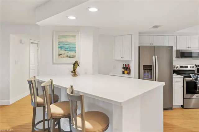 a kitchen with a sink appliances and cabinets