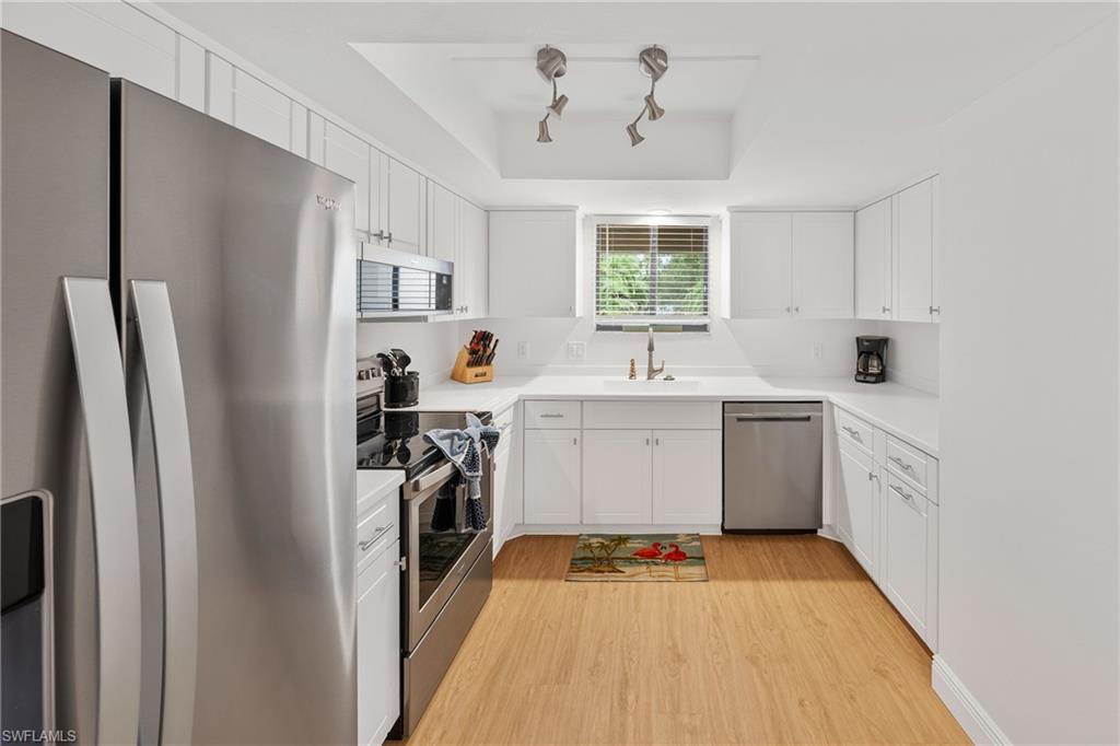 801 Islamorada Boulevard, Unit 22B Punta Gorda, FL 33955 - Photo 9 of 48 a kitchen with a sink appliances and cabinets