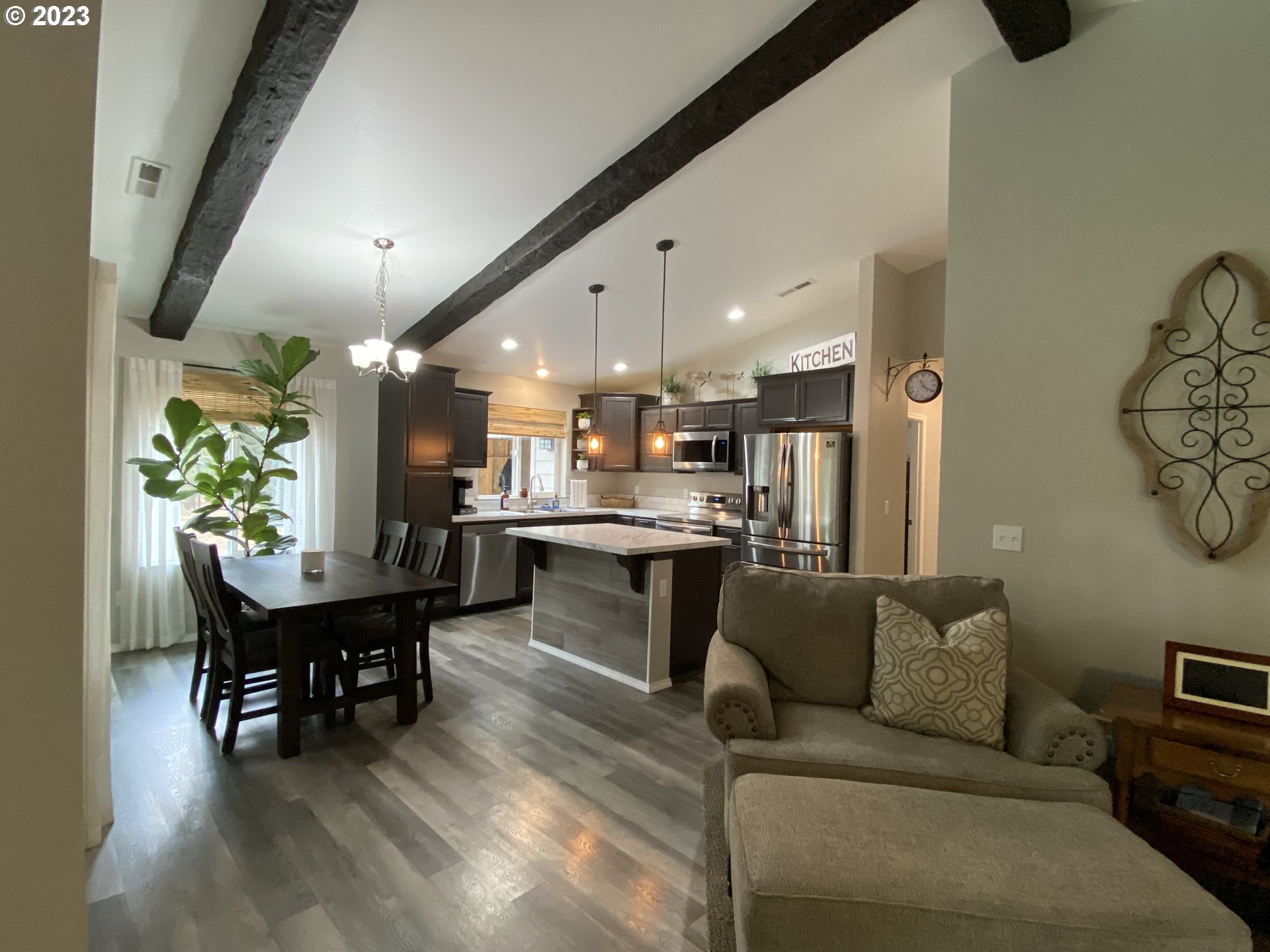227 Locust Lane Goldendale, WA 98620 - Photo 11 of 48 a living room with furniture and a dining table with kitchen view