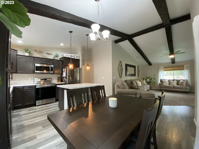 a large kitchen with a table and chairs