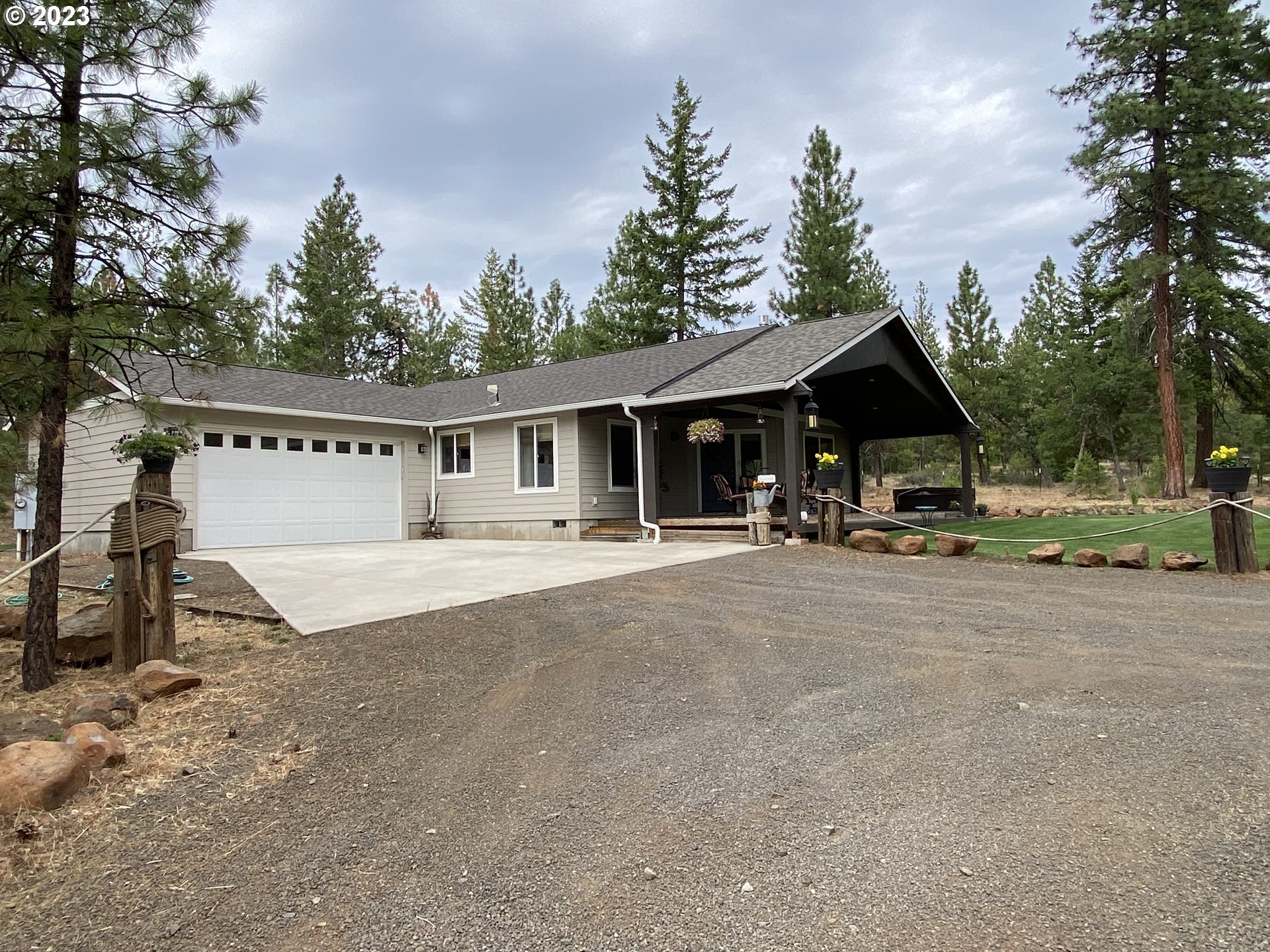 227 Locust Lane Goldendale, WA 98620 - Photo 2 of 48 a view of a patio with couches and table and chairs with wooden fence and floor