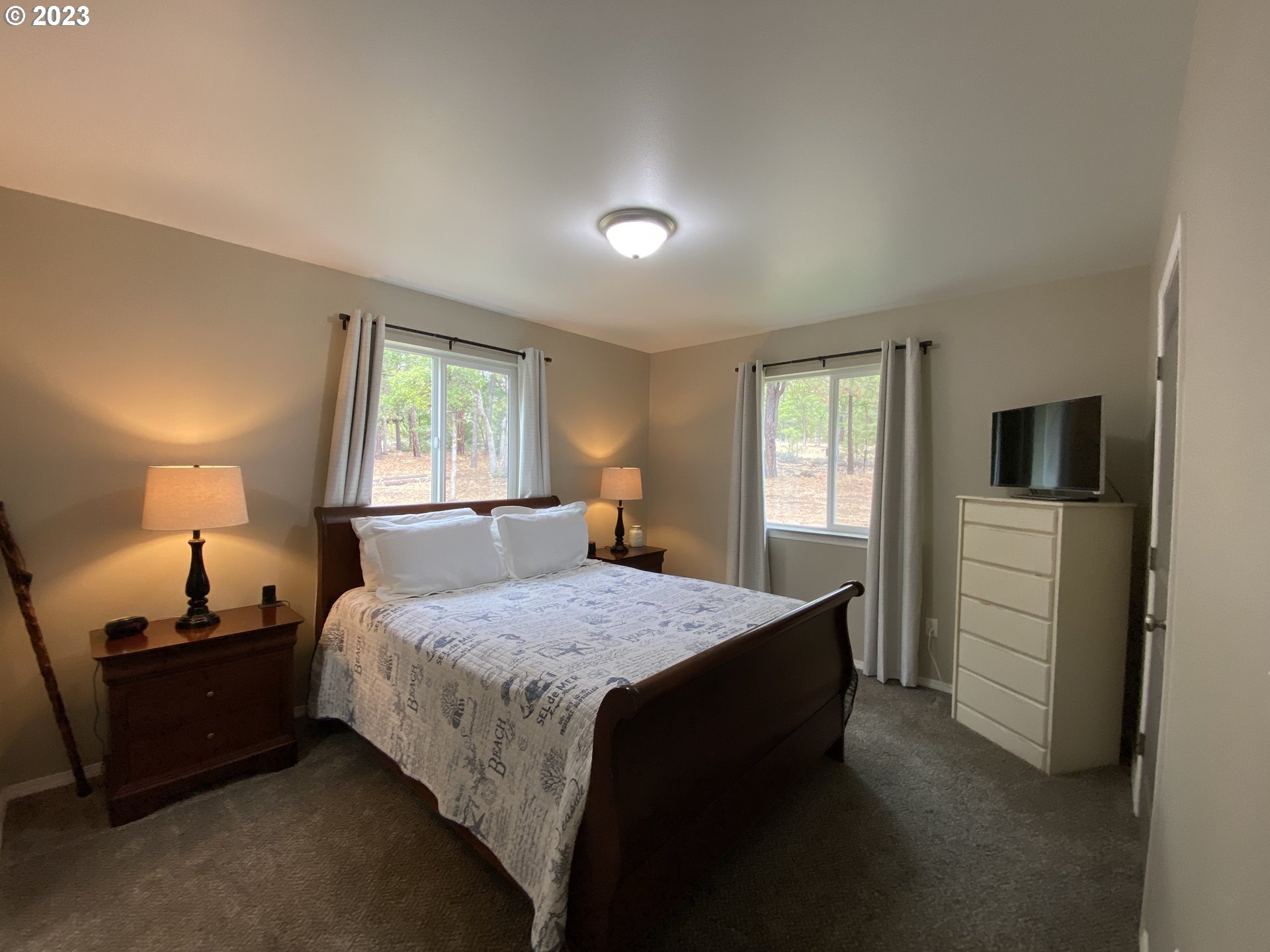 227 Locust Lane Goldendale, WA 98620 - Photo 24 of 48 a bedroom with a bed and a tv on the dresser