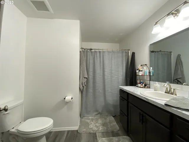 a bathroom with a toilet sink and shower