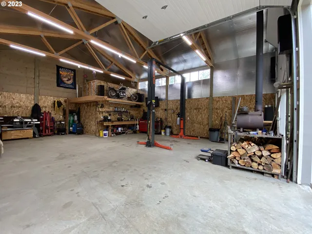a view of a backyard with wooden fence and large trees
