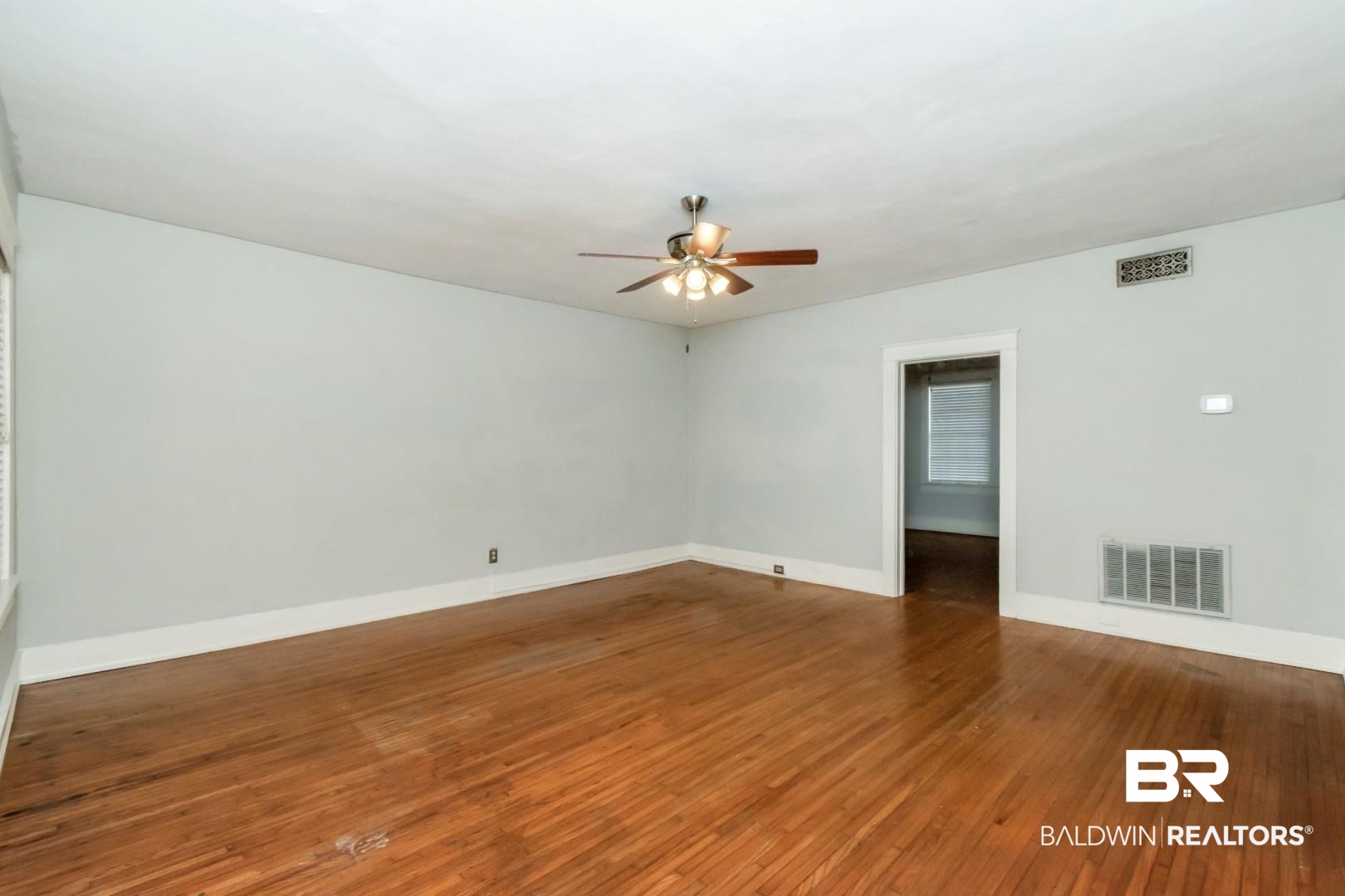 1602 Government Street, Unit 1A Mobile, AL 36604 - Photo 5 of 24 Unfurnished room featuring dark wood finished floors and a ceiling fan