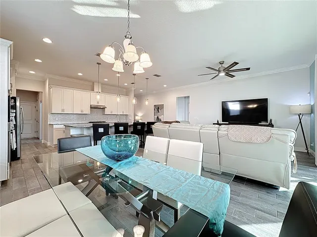 a living room with furniture and a view of kitchen