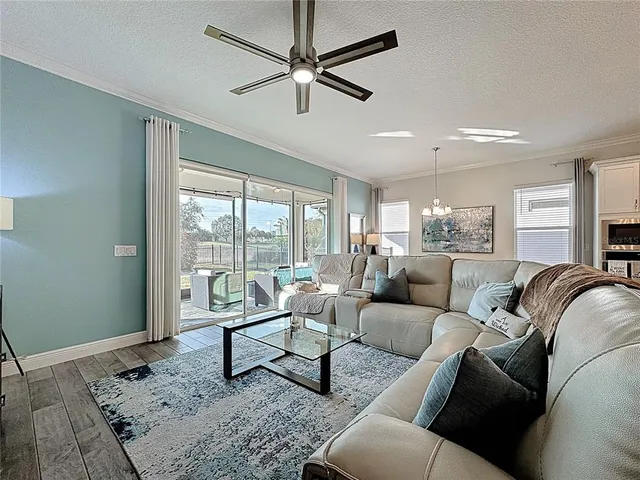 a spacious bedroom with a bed and a chandelier