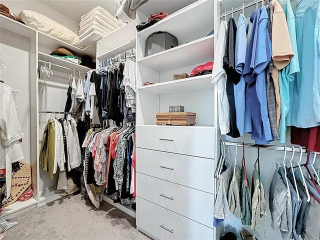 a bedroom with a large bed and a night stand