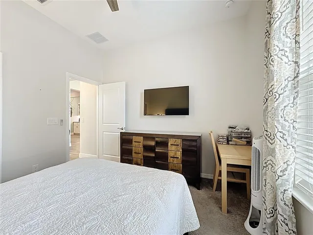 a bedroom with a bed and a night stand