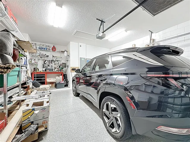 a living room with couches a dining table and chairs with a large window