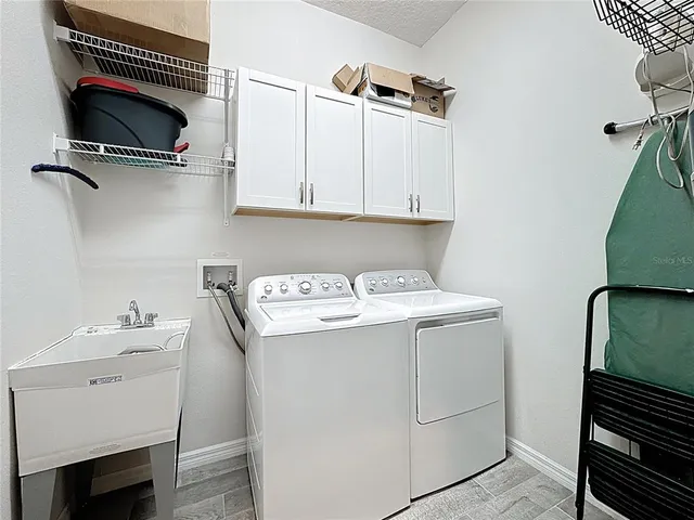 a utility room with dryer washer and other items