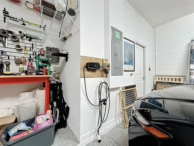 a living room with patio furniture and a floor to ceiling window