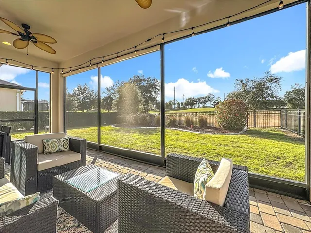 a front view of a house with a yard and potted plants