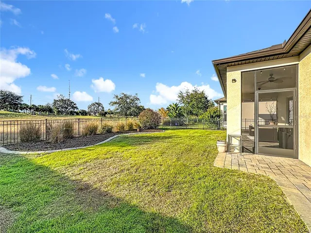 a view of a house with backyard and sitting area