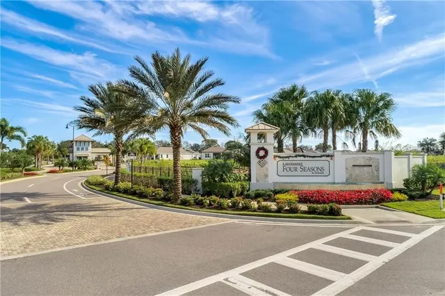 a living room with furniture and floor to ceiling windows