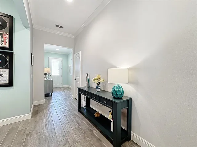 a hallway with table and flowerpot