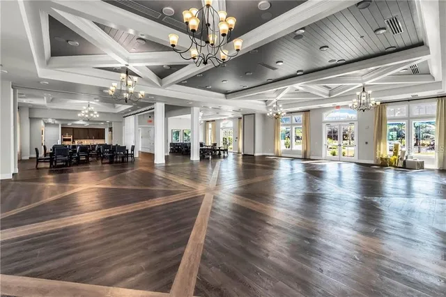 a view of a a dining room with furniture window and wooden floor