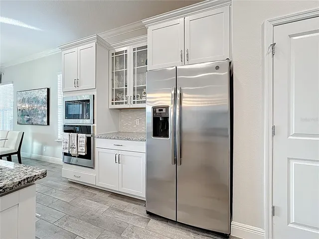 a kitchen with stainless steel appliances a refrigerator a stove and cabinets
