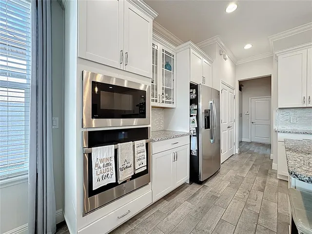 a kitchen with white cabinets and a stove