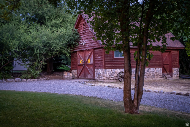 435 Canyon Road Millville, UT 84326 - Photo 92 of 113 Rustic outbuilding featuring vertical wood siding, a gable roof, and a stone foundation