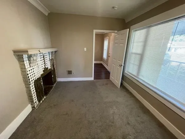 a view of an empty room with a fireplace