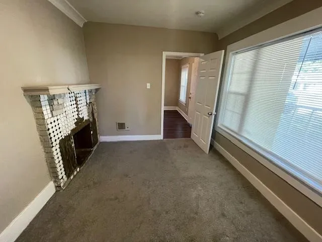 a view of an empty room with a fireplace