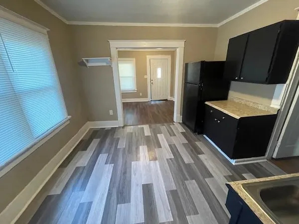 a view of a kitchen from a corridor