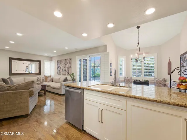 a living room with furniture a window and a chandelier