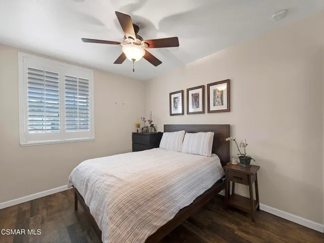 a bedroom with a large bed and a desk