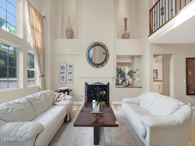 a living room with furniture a window and a chandelier