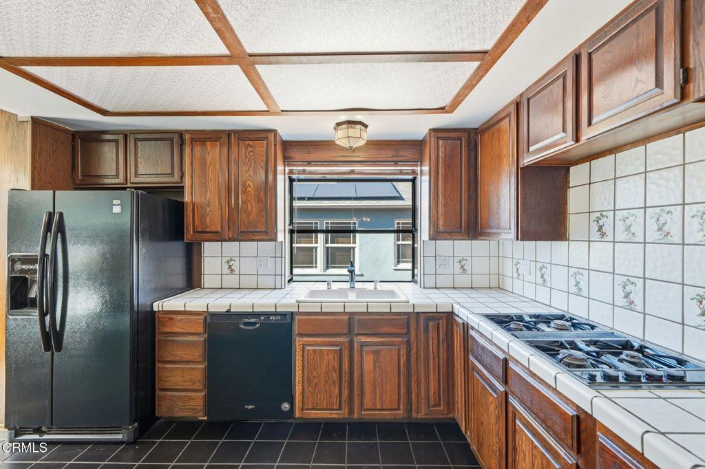 672 West Mendocino Street Altadena, CA 91001 - Photo 11 of 33 a kitchen with stainless steel appliances granite countertop a stove a sink dishwasher and a refrigerator