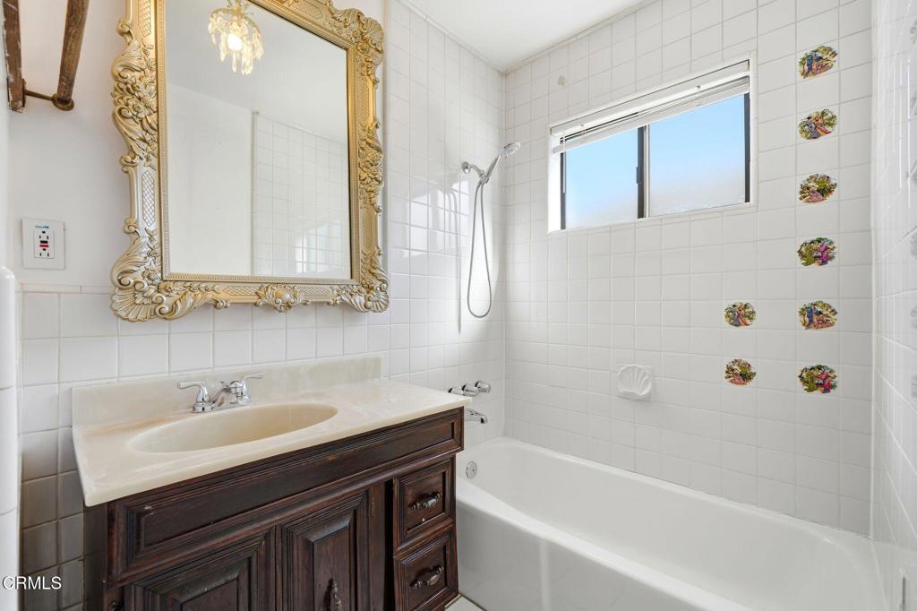 672 West Mendocino Street Altadena, CA 91001 - Photo 22 of 33 a bathroom with a sink a mirror a bathtub and shower