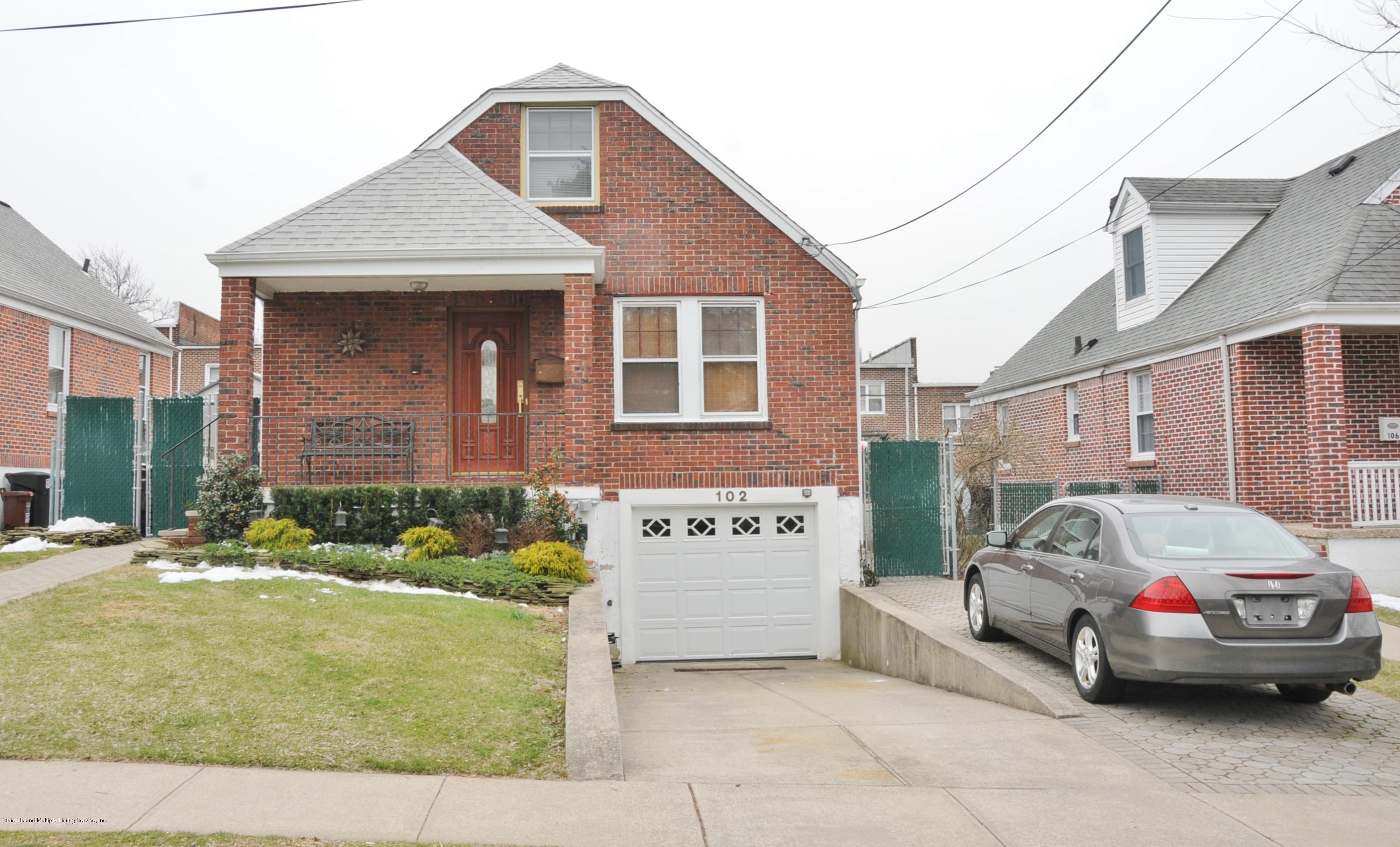 102 Governor Road Staten Island, NY 10314 - Photo 2 of 6 a front view of a house with garage