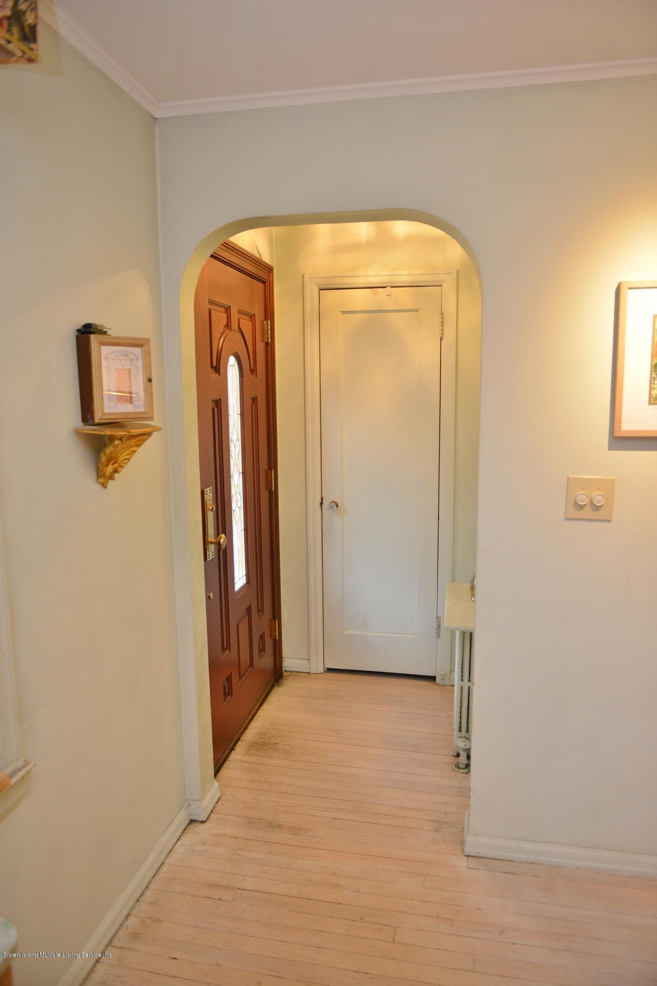 102 Governor Road Staten Island, NY 10314 - Photo 3 of 6 a view of front door with a mirror