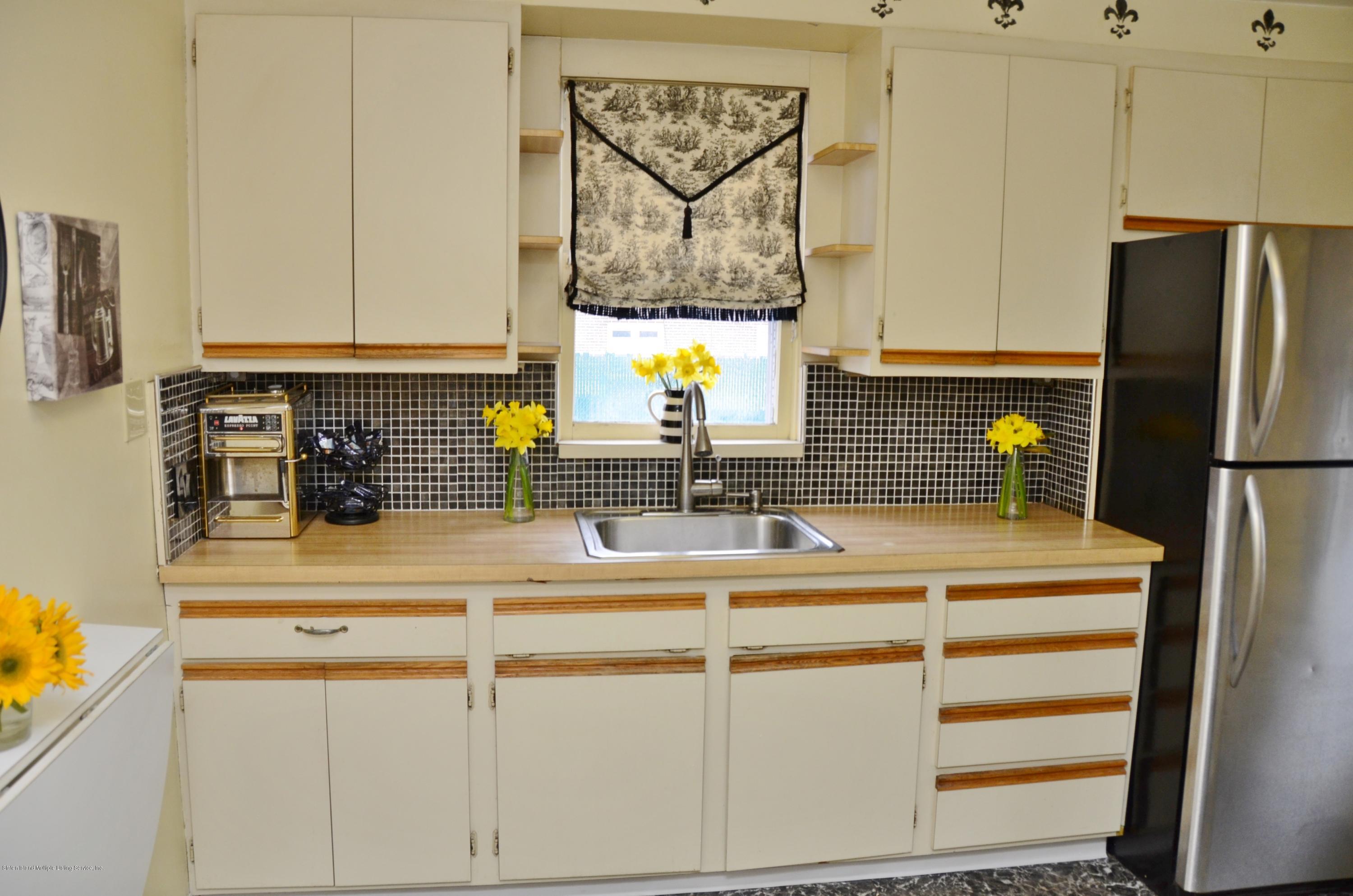 102 Governor Road Staten Island, NY 10314 - Photo 5 of 6 a kitchen with a refrigerator and a sink