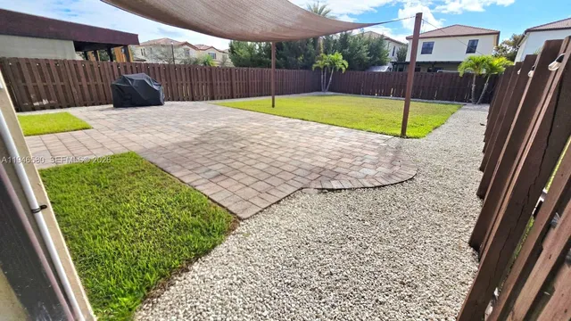 a view of a house with wooden fence