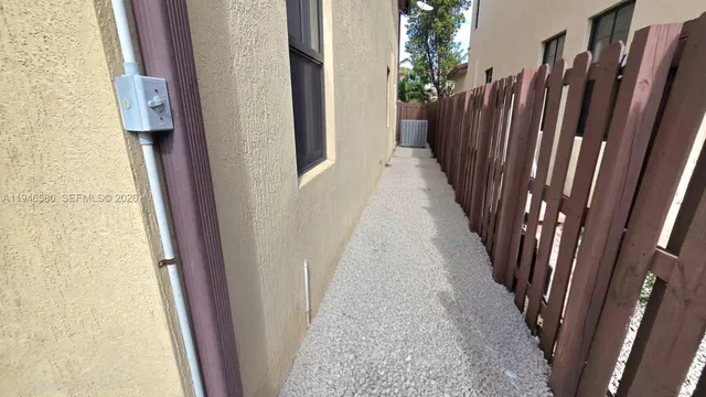 a hallway with furniture and a flat screen tv