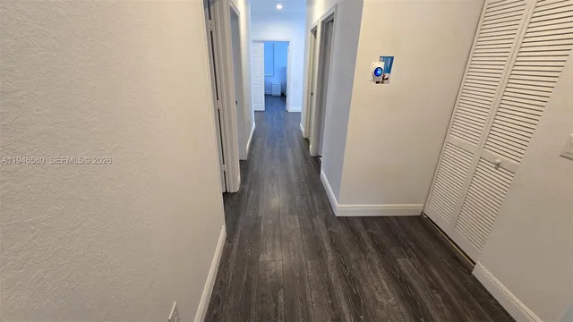 a view of workspace with wooden floor windows cabinet and chair