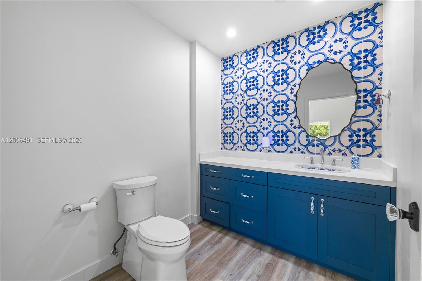 22275 Southwest 256th Street Homestead, FL 33031 - Photo 11 of 57 a bathroom with a toilet sink vanity and mirror