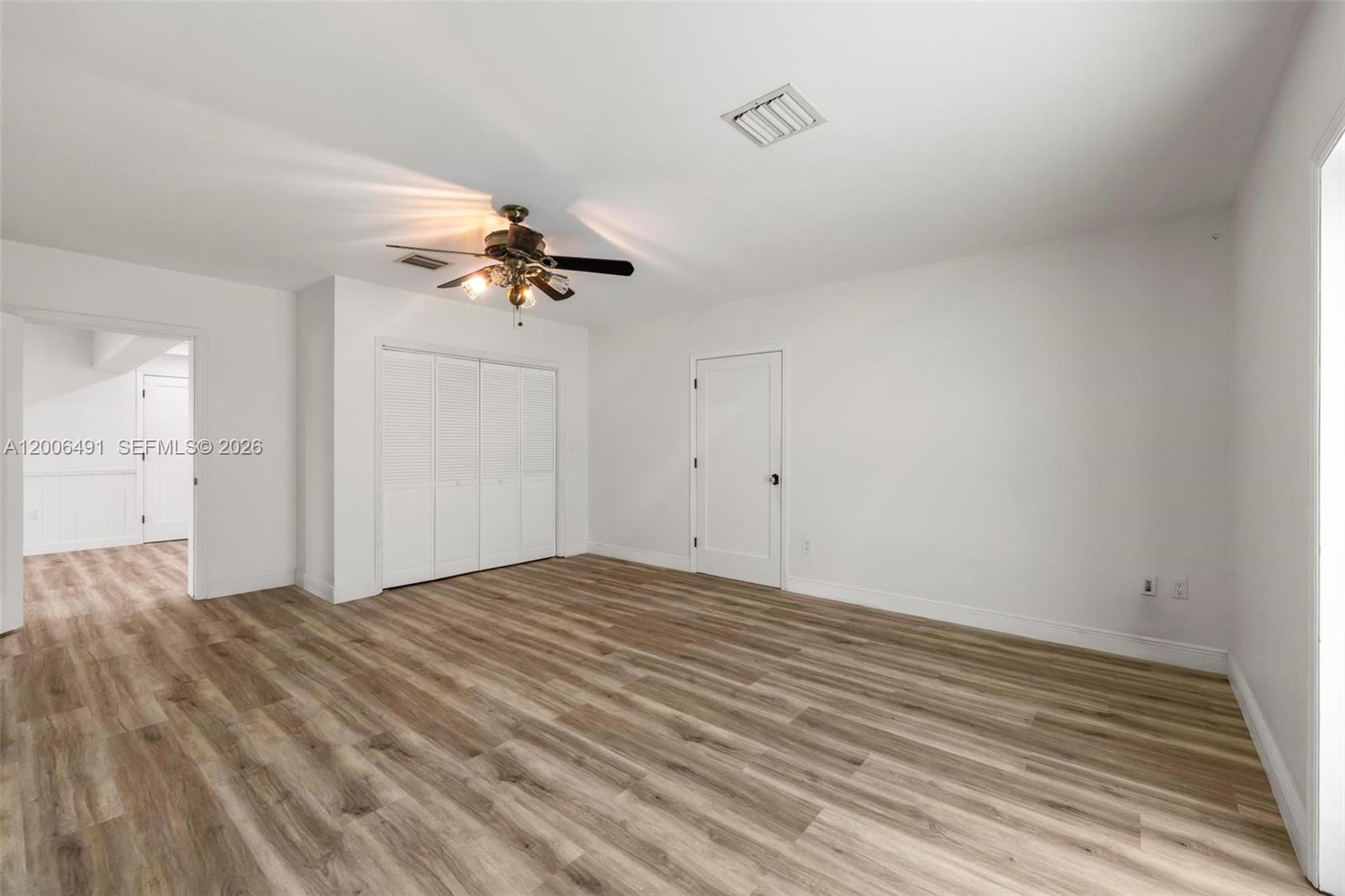 22275 Southwest 256th Street Homestead, FL 33031 - Photo 15 of 57 a view of an empty room with a chandelier fan